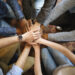 Top view of diverse people hands holding together in circle, hands stack, close up