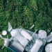 Food plastic packaging, trash on green moss background after picnic in forest. Top view. Copy space. Recycling plastic. Environmental pollution, ecology concept. Reuse garbage, recycle, plastic free
